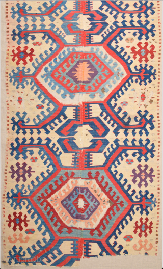 This impressive white-ground kilim is a weaving of the Hotamis Turkmen of the Konya region. It is woven in one piece, so unlike the two-panel kilims of this group there is no  ...