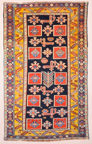 East Caucasian Karagashli Rug Ten red box shapes with a central rosette lie along the central axis of the blue field, interspersed with the abstract birds that are characteristic of the provenance;  ...