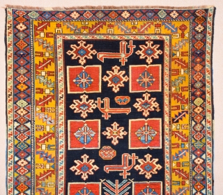 East Caucasian Karagashli Rug Ten red box shapes with a central rosette lie along the central axis of the blue field, interspersed with the abstract birds that are characteristic of the provenance;  ...