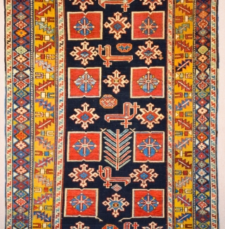 East Caucasian Karagashli Rug Ten red box shapes with a central rosette lie along the central axis of the blue field, interspersed with the abstract birds that are characteristic of the provenance;  ...