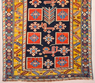 East Caucasian Karagashli Rug Ten red box shapes with a central rosette lie along the central axis of the blue field, interspersed with the abstract birds that are characteristic of the provenance;  ...