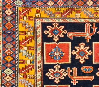 East Caucasian Karagashli Rug Ten red box shapes with a central rosette lie along the central axis of the blue field, interspersed with the abstract birds that are characteristic of the provenance;  ...