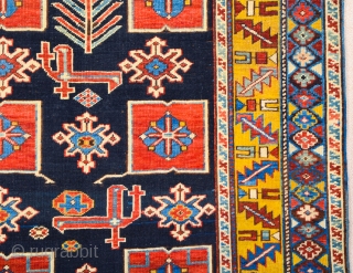 East Caucasian Karagashli Rug Ten red box shapes with a central rosette lie along the central axis of the blue field, interspersed with the abstract birds that are characteristic of the provenance;  ...