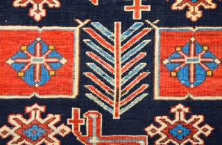 East Caucasian Karagashli Rug Ten red box shapes with a central rosette lie along the central axis of the blue field, interspersed with the abstract birds that are characteristic of the provenance;  ...