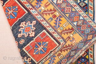 East Caucasian Karagashli Rug Ten red box shapes with a central rosette lie along the central axis of the blue field, interspersed with the abstract birds that are characteristic of the provenance;  ...