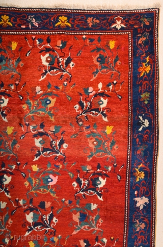 South Caucasian Karabagh Rug. In the Red field, short stems arranged in parallel rows combine into a dense repeat in shades of green, red and pink. Each stem bears a large blossom.  ...