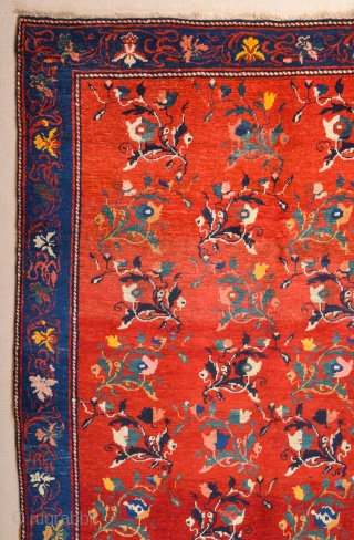 South Caucasian Karabagh Rug. In the Red field, short stems arranged in parallel rows combine into a dense repeat in shades of green, red and pink. Each stem bears a large blossom.  ...