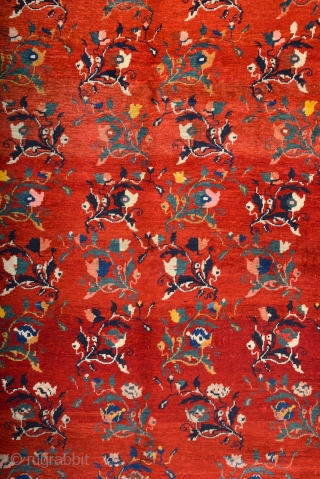 South Caucasian Karabagh Rug. In the Red field, short stems arranged in parallel rows combine into a dense repeat in shades of green, red and pink. Each stem bears a large blossom.  ...