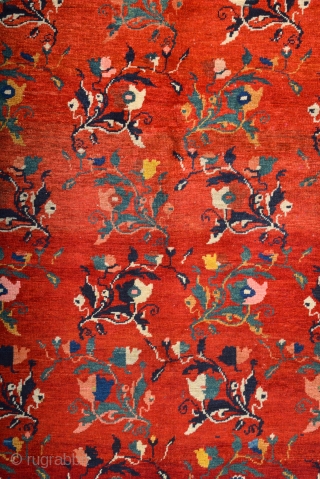 South Caucasian Karabagh Rug. In the Red field, short stems arranged in parallel rows combine into a dense repeat in shades of green, red and pink. Each stem bears a large blossom.  ...