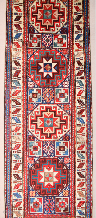 19th Century This very beautiful long rug from the Genje area presents a field design of polychrome diagonal stripes decorated with small usual medallion motifs. The distribution of the colours in the  ...