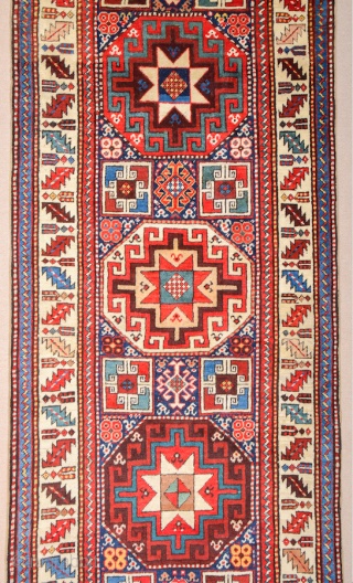 19th Century This very beautiful long rug from the Genje area presents a field design of polychrome diagonal stripes decorated with small usual medallion motifs. The distribution of the colours in the  ...