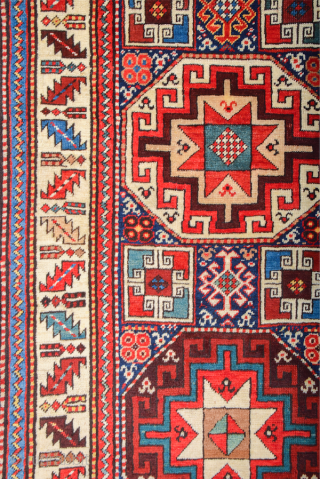 19th Century This very beautiful long rug from the Genje area presents a field design of polychrome diagonal stripes decorated with small usual medallion motifs. The distribution of the colours in the  ...