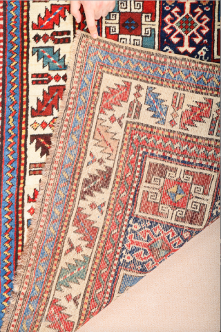 19th Century This very beautiful long rug from the Genje area presents a field design of polychrome diagonal stripes decorated with small usual medallion motifs. The distribution of the colours in the  ...