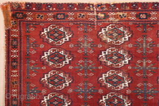 Central Asia West Turkestan Early 19th Century Saryk.This large Saryk Chuval displays twelve primary güls and chemche secondary designs in a dark red field. The main border contains diagonal crosses and hooked  ...