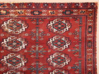 Central Asia West Turkestan Early 19th Century Saryk.This large Saryk Chuval displays twelve primary güls and chemche secondary designs in a dark red field. The main border contains diagonal crosses and hooked  ...