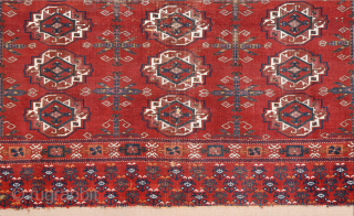 Central Asia West Turkestan Early 19th Century Saryk.This large Saryk Chuval displays twelve primary güls and chemche secondary designs in a dark red field. The main border contains diagonal crosses and hooked  ...