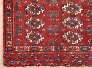 Central Asia West Turkestan Early 19th Century Saryk.This large Saryk Chuval displays twelve primary güls and chemche secondary designs in a dark red field. The main border contains diagonal crosses and hooked  ...