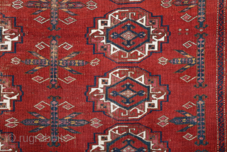 Central Asia West Turkestan Early 19th Century Saryk.This large Saryk Chuval displays twelve primary güls and chemche secondary designs in a dark red field. The main border contains diagonal crosses and hooked  ...