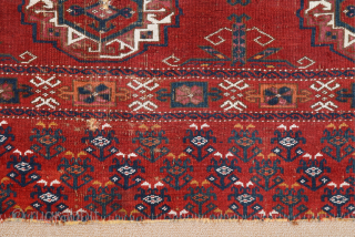 Central Asia West Turkestan Early 19th Century Saryk.This large Saryk Chuval displays twelve primary güls and chemche secondary designs in a dark red field. The main border contains diagonal crosses and hooked  ...