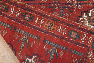 Central Asia West Turkestan Early 19th Century Saryk.This large Saryk Chuval displays twelve primary güls and chemche secondary designs in a dark red field. The main border contains diagonal crosses and hooked  ...