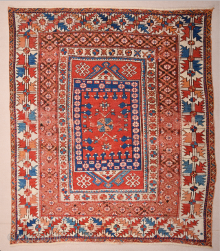 In this red-ground Late 18th Century West Anatolian Bergama, a powerful dark blue shield form encloses a large red stepped motif of almost the same size as well as a smaller, green  ...