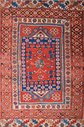 In this red-ground Late 18th Century West Anatolian Bergama, a powerful dark blue shield form encloses a large red stepped motif of almost the same size as well as a smaller, green  ...