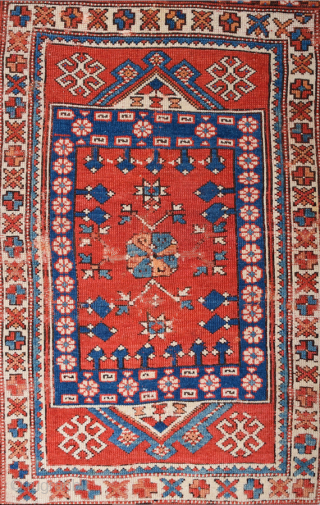 In this red-ground Late 18th Century West Anatolian Bergama, a powerful dark blue shield form encloses a large red stepped motif of almost the same size as well as a smaller, green  ...