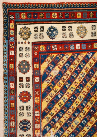 Middle of 19th Century South East Caucasian example, with an yellow and blue field and large rosettes in the white-ground main border, serves as a particularly good illustration of the design affinity  ...