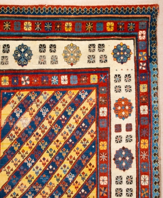 Middle of 19th Century South East Caucasian example, with an yellow and blue field and large rosettes in the white-ground main border, serves as a particularly good illustration of the design affinity  ...