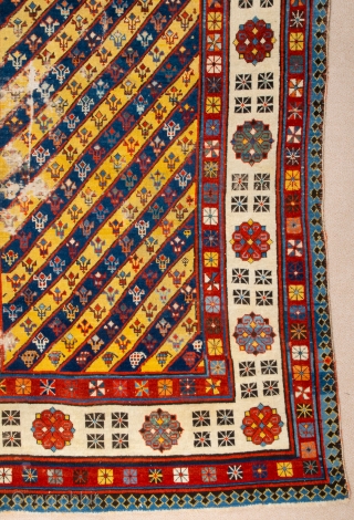 Middle of 19th Century South East Caucasian example, with an yellow and blue field and large rosettes in the white-ground main border, serves as a particularly good illustration of the design affinity  ...