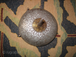 A fine Persian Safavid helmet c 1700. Heavy silver inlay with an engraved lattice pattern and floral sprays in a style seen in some "Vase" carpets. There is gold plating around the  ...