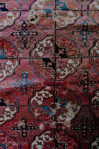 An early Turkmen main carpet, probably Tekke, with nicely proportioned guls, a bold 'boat' main border and interesting minor borders. Localized heavy wear, holes and other losses, with some fading and stains.  ...