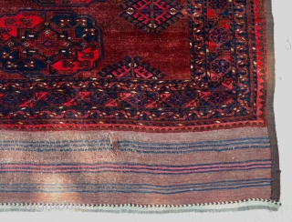 Description and origin: antique Ersari carpet, from Turkmenistan. A soft red ground with three columns of eleven large Guls surrounded by a narrow angular border. Excellent pile with slight surface mark, attractive  ...