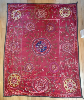 Description and origin: traditional suzani from Uzbekistan, with astral and vegetal designs. Silk and cotton. 

Dimensions: approx. 190 x 143 cm

Age: around 1940

Condition: very good (see pictures)      