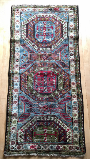 Origin and description: Caucasian carpet with traditional stars´ borders and a main field between Farchalo and Karachopf designs. Interesting dominance of green colour.

Age: around 100 years old.

Dimensions: 224 cm x 107 cm.

Condition:  ...