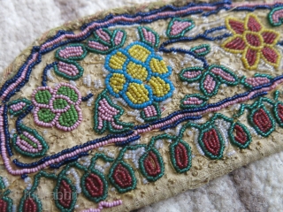 Glass beaded panel with floral designs.                           