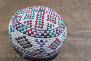 Turkmen Yomud Goklan baby hat, silk embroidery on plain cotton. Circa 1920-40s. 
Size: 4” circumference – 2” tall (10 cm × 5 cm).          