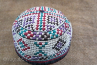 Turkmen Yomud Goklan baby hat, silk embroidery on plain cotton. Circa 1920-40s. 
Size: 4” circumference – 2” tall (10 cm × 5 cm).          