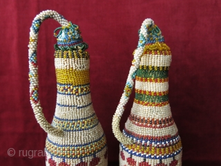 A pair of antique micro glass beaded bottle jackets. Presumably made by Greeks in Western Turkey in late 19th century. Despite their age, they are in great condition. Even the corks are  ...