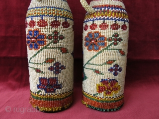 A pair of antique micro glass beaded bottle jackets. Presumably made by Greeks in Western Turkey in late 19th century. Despite their age, they are in great condition. Even the corks are  ...