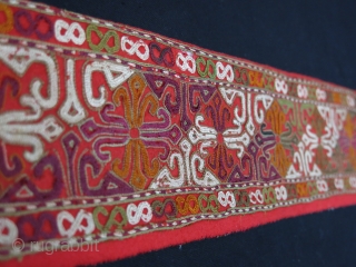 Turkmen Chodor silk embroidered costume fragment. Adras ikat backing. Circa 1900.
Size: 120 cm x 10 cm (47.2"x 3.9").               