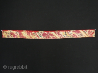 Turkmen Chodor silk embroidered costume fragment. Adras ikat backing. Circa 1900.
Size: 120 cm x 10 cm (47.2"x 3.9").               
