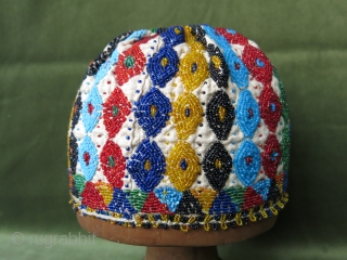 Turkish Kutahya region glass beaded and embroidered hat with tiny beaded tassels at the edges. Height: 14 cm (5.5") x 56 cm in diameter (22").        