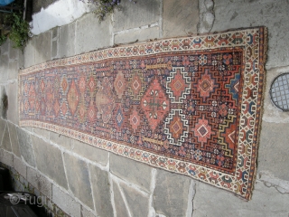 a very beautiful mid or early 19th century nw persian ?kurdish runner. Approx 15ft x 3ft. I think it's missing an outer guard there are condition issues. Low parts two very old  ...