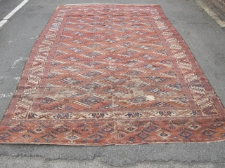 An unusual Antique Turkoman main carpet. Size 11ft 4 x 6ft9. Unusual border design. Not in the best condition wear to one end sides not original.A very attractive carpet.    