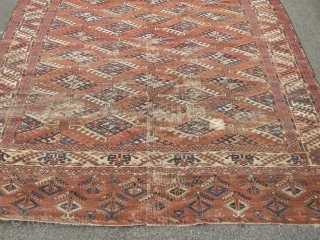 An unusual Antique Turkoman main carpet. Size 11ft 4 x 6ft9. Unusual border design. Not in the best condition wear to one end sides not original.A very attractive carpet.    