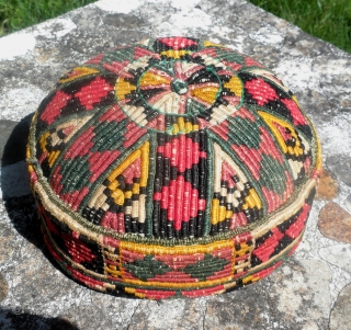 Here is a lovely old Karapalpak hat.
Measureing 7" in diameter and 3"+ tall.
Useing a silk warp wraping technique the
hat is in reasonable condition dateing to
the early 20th. century.      ...