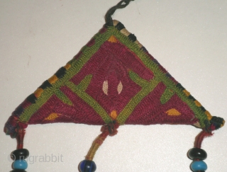 Here is a beautiful old Saryk Turkoman embroidered Talisman/Amulet which would have been worn to ward off evil/bring good luck. The talisman is embroidered in five colors of silk thread: white, yellow,green,cochineal  ...