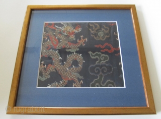 A gold brocaded dragon among clouds chasing the flaming pearl. The fragment is 15cm high and 16,5cm wide. Size of the frame is 25x26cm.
Although the style of the dragon, clouds and colouring  ...