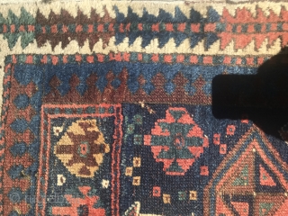 19th Century Kurdish rug with some damaged areas.                         